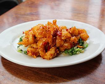 Product: crispy large shrimp is tossed in a tangy spicy sauce. served over chinese broccoli and napa cabbage. served with white rice - Hub 51 in River North - Chicago, IL American Restaurants