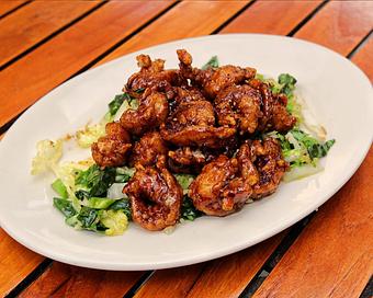 Product: crispy large shrimp are tossed in a rich, peppery soy sauce. served over chinese broccoli and napa cabbage. served with rice - Hub 51 in River North - Chicago, IL American Restaurants