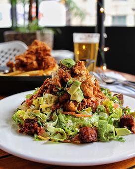 Product: buttermilk fried crispy chicken tenders, cornbread croutons, tillamook cheese, bacon, avocado, tomato, cucumber, carrot, scallion - Hub 51 in River North - Chicago, IL American Restaurants