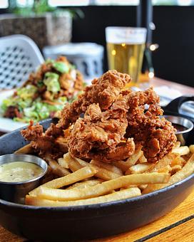 Product: buttermilk fried crispy chicken served with honey mustard and barbecue sauce over a bed of crispy Hub french fries - Hub 51 in River North - Chicago, IL American Restaurants