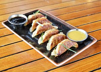 Product: six potstickers are filled with chicken and cabbage and pan fried until golden brown. served with a housemade sauce of soy, garlic, ginger and citrus - Hub 51 in River North - Chicago, IL American Restaurants