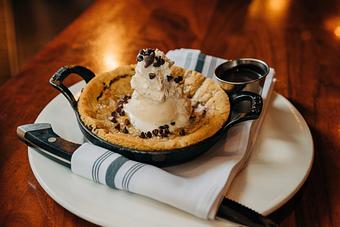 Product: home-made chocolate chip cookie, topped with vanilla bean ice cream, hot fudge, finished with whipped cream and chocolate chips - Hub 51 in River North - Chicago, IL American Restaurants