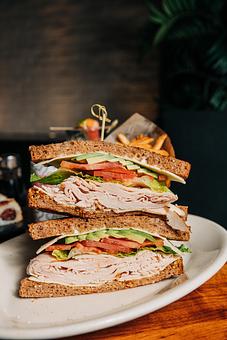 Product: 9-grain bread, stacked shaved turkey, lettuce, tomato, avocado, mayo, stone ground mustard. - Hub 51 in River North - Chicago, IL American Restaurants