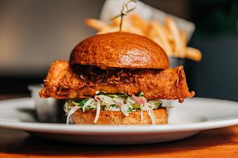 Product: choice of grilled or fried mahi mahi, with jalapeno slaw, pickled red onion and chipotle mayo in a sliced brioche bun. served with crispy Hub french fries - Hub 51 in River North - Chicago, IL American Restaurants