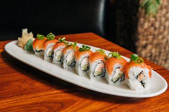 Product: nori seaweed wrapped with sushi rice, spicy rock crab, cucumber and cream cheese. topped with smoked salmon and scallions. sliced into eight pieces and served with soy sauce, pickled ginger and wasabi - Hub 51 in River North - Chicago, IL American Restaurants