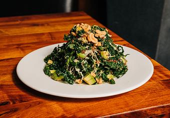 Product: chopped kale is tossed with mustard vinaigrette, shredded green cabbage, orange, avocado and red quinoa. finished with roasted cashews - Hub 51 in River North - Chicago, IL American Restaurants