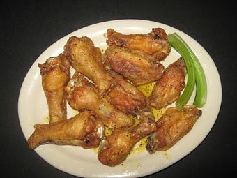 Product: 10 pieces, Lemon Pepper wings served with celery and dressing - Irish Bred Pub in Hapeville, GA American Restaurants