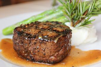 Product: 8 oz. filet rubbed with porcini mushroom, grilled and served with roasted garlic mashed potatoes, asparagus and veal demi-glace. - JJ's Restaurant in Kansas City, MO French Restaurants