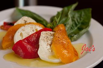 Product: Fresh House made Fiore di Latte ( fresh Mozzarella) with roasted Yellow, Red Peppers and Basil - Joes Dining in Santa Fe, NM Pizza Restaurant