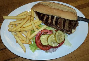 Product: 9 oz. New York steak cut right off of the strip. - Johnny's Bar & Grill in Hollister, CA American Restaurants