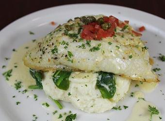 Product: Rosemary seasoned grouper, stuffed with homemade crab cake mix, seared and oven baked over a bed of cheddar mashed potatoes. Served with sauteed baby spinach and jumbo lump crab meat - Jubilee Joe's Cajun Seafood Restaurant in Hoover, AL Seafood Restaurants
