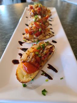 Product: Tomato, Capers, Shallot, bell pepper, Balsamic, on a crostini - Kelso Theater Pub and Backstage Cafe in Downtown Kelso Wa. - Kelso, WA American Restaurants