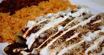 Product: (3) Rolled Corn Tortillas stuffed with your choice of meat and doused in an authentic Mole made of a closely guarded Old World combination of Dried Peppers & Spices, served with (2) Sides - La Lupita Tacos Mexicanos in Olneyville - Providence, RI Mexican Restaurants