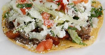 Product: Steak & Chorizo Mixed Tostada (Regular) A flat crispy Corn Tortilla topped with Meat, Onion, Cilantro, Lettuce, Tomato, Cotija Cheese & Sour Cream - La Lupita Tacos Mexicanos in Olneyville - Providence, RI Mexican Restaurants