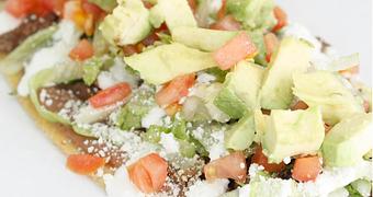 Product: Steak Huarache (Supreme) A handmade oval shaped Corn Tortilla smothered with Refried Beans and topped with Meat, Onion, Cilantro, Lettuce, Cotija Cheese, Sour Cream & Avocado. - La Lupita Tacos Mexicanos in Olneyville - Providence, RI Mexican Restaurants