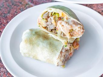 Product: Soft Flour Tortilla packed with Meat, Yellow Rice, Refried or Whole Beans, Onion, Cilantro, Lettuce, Tomato, Mozzarella Cheese & Sour Cream - La Lupita Tacos Mexicanos in Olneyville - Providence, RI Mexican Restaurants