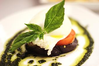 Product: Creamy Italian mozzarella served over roasted eggplant & sliced tomato in a basil pesto sauce - La Mezzaluna in Princeton, NJ Italian Restaurants