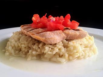 Product: Fresh-caught salmon served with an herb risotto & tomato bruschetta - La Mezzaluna in Princeton, NJ Italian Restaurants