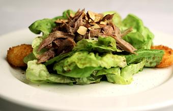 Product: Butter lettuce tossed in an agro-dolce balsamic with crisp goat cheese & toasted almonds, topped with braised duck - La Mezzaluna in Princeton, NJ Italian Restaurants
