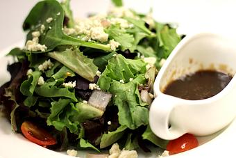 Product: Fresh greens, gorgonzola & grape tomatoes tossed in a homemade vinaigrette - La Mezzaluna in Princeton, NJ Italian Restaurants
