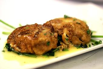 Product: Pan-seared artichoke cake sauteed in butter & lemon, served over spinach - La Mezzaluna in Princeton, NJ Italian Restaurants