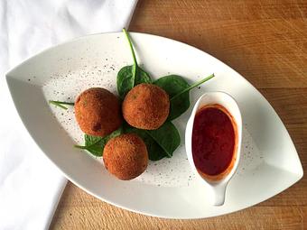 Product: Homemade risotto, mozzarella and peas deep-fried & served with fresh marinara - La Mezzaluna in Princeton, NJ Italian Restaurants