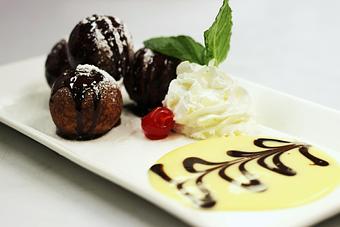 Product: Shallow-fried ricotta & semi-sweet chocolate morsels dusted with sugar & homemade chocolate sauce - La Mezzaluna in Princeton, NJ Italian Restaurants