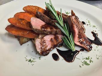 Product: Roasted Duck Breast, roasted local carrots, mashed potatoes, balsamic reduction. - Landmark Cafe & Creperie in Galesburg, IL American Restaurants