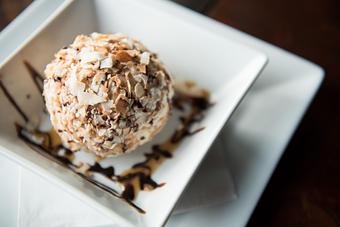 Product: Vanilla bean ice cream in a crisp coconut crumb coating topped with chocolate and caramel sauce. - Las Brisas Mexican Restaurant in Edmonds, WA Steak House Restaurants