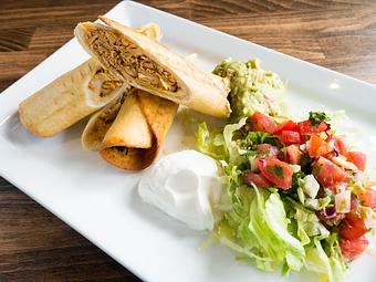 Product: Crisp flour tortillas filled with chicken and topped with lettuce, tomatoes, onions, guacamole and sour cream. - Las Brisas Mexican Restaurant in Edmonds, WA Steak House Restaurants