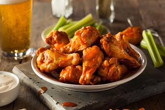 Product: Chicken Wings with a choice of chipotle barbeque or traditional hot served with veggies and blue cheese or ranch dressing - Level 9 Rooftop Bar in East Village - San Diego, CA American Restaurants