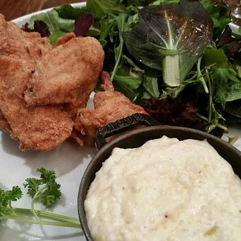 Product: Southern Fried Chicken with Green Chile Grits, Fresh Greens - Luminaria in Downtown Santa Fe - Santa Fe, NM American Restaurants