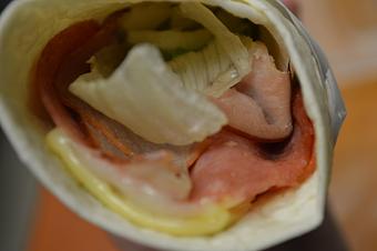 Product: Close up of a Italian wrap: Ham, pepperoni & salami with provolone & Swiss cheeses plus lettuce in a tortilla. - Mario's Pizza & Grill in Knoxville, TN Pizza Restaurant