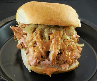 Product: Cluckin' Awesome pulled chicken sandwich - pulled Pepper Lime chicken, grilled onions, chipotle mayo on a sweet sourdough bun (lg). - Meyer's Elgin Smokehouse in Elgin, TX Barbecue Restaurants