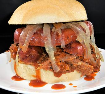 Product: Pigzilla sandwich - pulled pork, pork garlic sausage, grilled onions, honey mesquite bbq sauce. - Meyer's Elgin Smokehouse in Elgin, TX Barbecue Restaurants