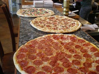 Product: The slice pies of the day - Mezza Luna Pizzeria - Downtown: in Eugene/Springfield, OR Pizza Restaurant