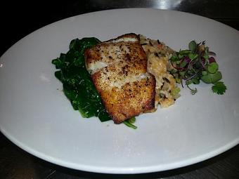 Product: Pan-seared Pacific Halibut over a Jasmine and wild rice pilaf with sauteed ice root spinach - Michael Anthony's at the Inn in Versailles, OH Restaurants/Food & Dining