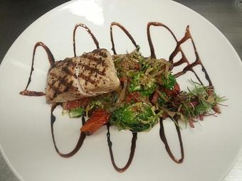 Product: Wood-fired Mahi Mahi over sauteed brussel sprouts with smoked pancetta, caramelized onions, shallots, and oven dried tomatoes garnished with balsamic reducti - Michael Anthony's at the Inn in Versailles, OH Restaurants/Food & Dining