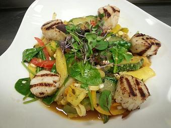 Product: Black pepper linguine with sweet corn, zucchini, squash, tri-color bell peppers, spinach, and fresh basil in a pan-made roasted garlic tomato, topped with grilled scallops - Michael Anthony's at the Inn in Versailles, OH Restaurants/Food & Dining