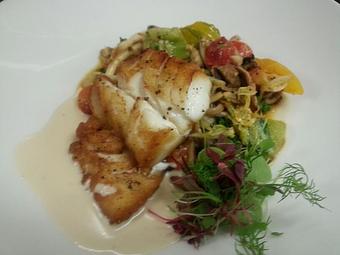 Product: Pan-seared Cod over sauteed wild mushrooms, heirloom tomatoes, and braised greens with a roasted garlic cream sauce - Michael Anthony's at the Inn in Versailles, OH Restaurants/Food & Dining