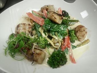 Product: Fresh egg linguine with sauteed bell peppers, broccoli, shallots in a sharp white cheddar and basil pesto cream sauce topped with wood fired scallops - Michael Anthony's at the Inn in Versailles, OH Restaurants/Food & Dining