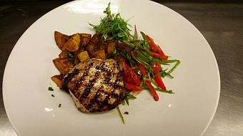 Product: Grilled Block-Island Swordfish with Cajun seasoning, served over sautéed snow peas, cherry tomatoes, red bell peppers and shallots with a side of seasoned crispy Yukon Gold potatoes - Michael Anthony's at the Inn in Versailles, OH Restaurants/Food & Dining