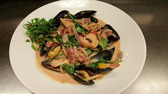 Product: Fresh whole wheat linguine with Prince Edward Island mussels, salmon belly, fresh basil, spinach, red onion and garlic in a Sambuca Pomarosa sauce - Michael Anthony's at the Inn in Versailles, OH Restaurants/Food & Dining