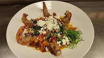 Product: Fresh spinach linguine with sauteed red onion, Chef Josh's heirloom tomatoes, basil, crispy bacon, kale, and arugula topped with feta cheese and grilled gulf shrimp - Michael Anthony's at the Inn in Versailles, OH Restaurants/Food & Dining