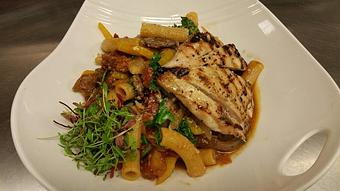 Product: Rigatoncini with sauteed crimini and porcini mushrooms, House-made deer sausage, kale, and bell peppers in a rustic tomato sauce with grilled chicken - Michael Anthony's at the Inn in Versailles, OH Restaurants/Food & Dining