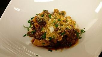 Product: Rigatoncini pasta with Porcini mushrooms, fresh kale, basil, and Italian sausage in a braised lamb and pork shank Ragu. Garnished with grated Parmigiana Reggiano and white truffle oil. - Michael Anthony's at the Inn in Versailles, OH Restaurants/Food & Dining