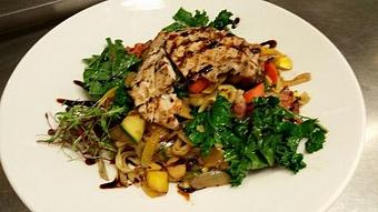 Product: Fresh egg linguine with sautéed yellow squash, heirloom carrots, zucchini, shallots, bell peppers, smoked pancetta, fresh basil and kale aglio e olio style, topped with grilled chicken and balsamic reduction. - Michael Anthony's at the Inn in Versailles, OH Restaurants/Food & Dining