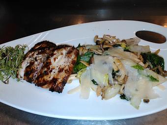 Product: Wood fired Mahi Mahi over sauteed wild mushrooms and braised greens, garnished with white truffle oil and shaved Parmigiana Reggiano cheese. - Michael Anthony's at the Inn in Versailles, OH Restaurants/Food & Dining