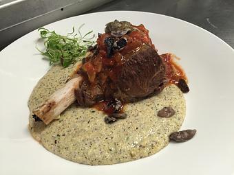 Product: Braised Lamb Shank
Shanks, braised in tomato, garlic, celery, onions, white wine and orange zest till moist and tender. Served with Hull’s Trace cheddar buckwheat polenta. - Michael Anthony's at the Inn in Versailles, OH Restaurants/Food & Dining