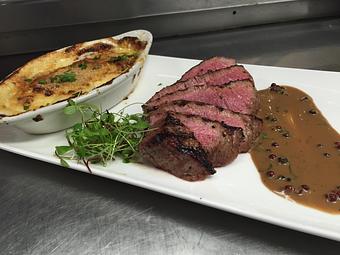 Product: London Broil
Hand cut inside round, wood fired and sliced thin with house made green peppercorn sauce and local heirloom potatoes au gratin. - Michael Anthony's at the Inn in Versailles, OH Restaurants/Food & Dining